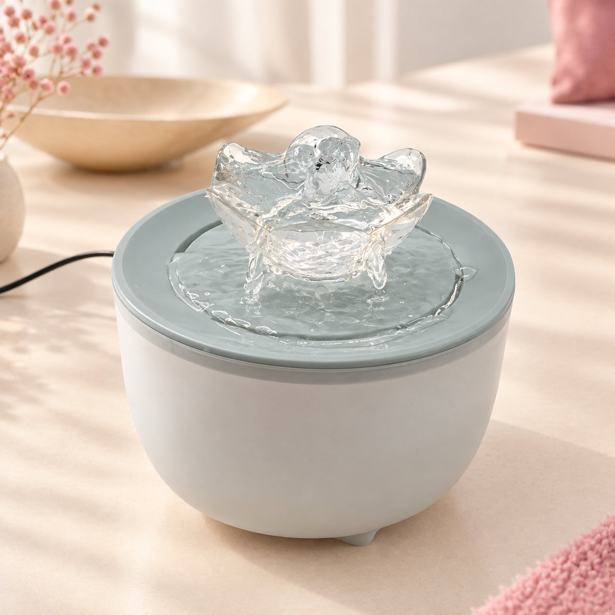 Fontaine à eau pour chat 1,2 L avec diffuseur en forme de lotus, coloris vert, posée sur une surface claire